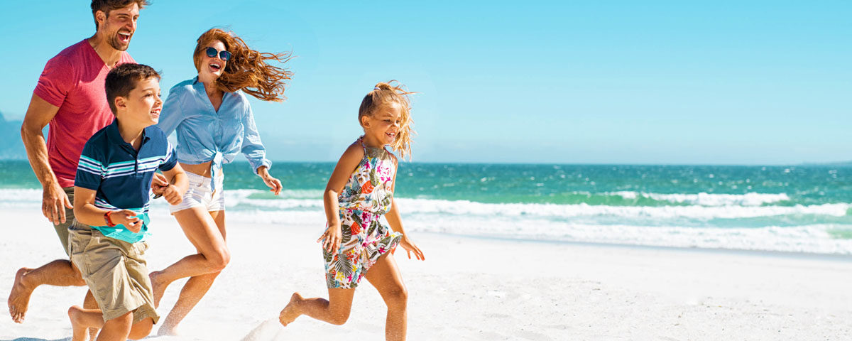 Happy family running on beach